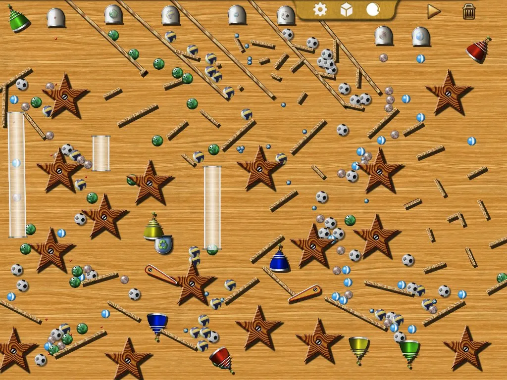 A BallFallDown board packed with ramps, spinners and tubes, with hundreds of balls in motion.
